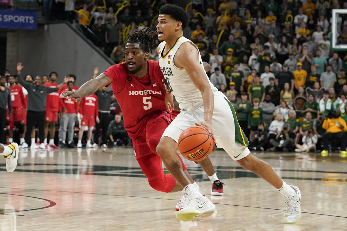 Feb 24, 2024; Waco, Texas, USA; Baylor Bears guard RayJ Dennis (10) works past Houston Cougars forward Ja'Vier Francis (5) during the second half at Paul and Alejandra Foster Pavilion. Mandatory Credit: Raymond Carlin III-USA TODAY Sports